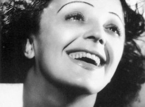 Photographie en noir et blanc d'Edith Piaf souriante